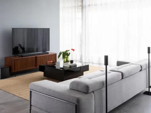 Surround 700 in a room with sofa on a table beside a wall