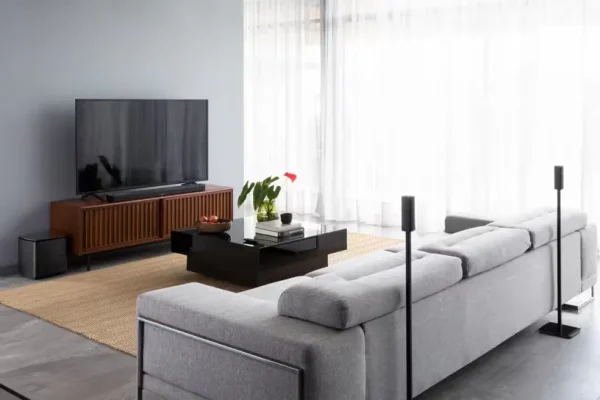 Surround 700 in a room with sofa on a table beside a wall